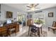 Home office with a large window, desk, and sliding glass door to sunroom at 17533 Se 96Th Ct, Summerfield, FL 34491