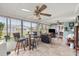 Sunroom featuring tile floors, large windows, barstools, and comfortable seating area at 17533 Se 96Th Ct, Summerfield, FL 34491