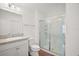 Bathroom featuring a vanity with granite countertop and a tiled walk-in shower at 1964 Rhett Rd, The Villages, FL 32163