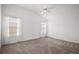 Bright bedroom with neutral carpet, ceiling fan, and natural light from two windows at 1964 Rhett Rd, The Villages, FL 32163