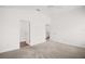 Empty bedroom with new carpet, ceiling fan and a view of the bathroom and closet at 1964 Rhett Rd, The Villages, FL 32163