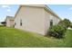 House exterior, showing a glimpse of the well-maintained yard and landscaping at 1964 Rhett Rd, The Villages, FL 32163