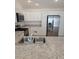 Bright kitchen featuring stainless steel appliances, white cabinets, and granite countertops at 1964 Rhett Rd, The Villages, FL 32163
