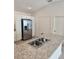 Eat-in kitchen featuring stainless steel appliances, granite countertops, and neutral cabinets at 1964 Rhett Rd, The Villages, FL 32163