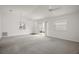 Large open living room with new carpet and light from the sliding doors at 1964 Rhett Rd, The Villages, FL 32163
