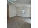 Open living room with vaulted ceilings and wood-look flooring at 1964 Rhett Rd, The Villages, FL 32163