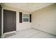 Covered patio with an exterior door and a window, with plenty of space for seating at 1964 Rhett Rd, The Villages, FL 32163