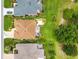 Aerial view showcasing a home with a screened-in pool, lush green lawn, and manicured landscaping at 219 Carrera Dr, The Villages, FL 32159