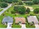 From above, a home nestled among others, green spaces, and a golf course presents a picture of community and leisure at 219 Carrera Dr, The Villages, FL 32159