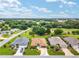 An elevated view showcases a well-landscaped property nestled within a community surrounded by lush greenery and a golf course at 219 Carrera Dr, The Villages, FL 32159