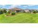 Well-manicured lawn with lush landscaping and a charming water fountain enhancing the curb appeal at 219 Carrera Dr, The Villages, FL 32159