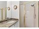 Bathroom showcasing granite counters, a mirrored vanity, and glass enclosed shower with white tiling at 219 Carrera Dr, The Villages, FL 32159