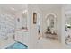 Hallway view showing bathroom with shower/tub combo and vanity in bright, neutral tones at 219 Carrera Dr, The Villages, FL 32159