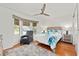 Cozy bedroom with natural light, wood flooring, and bay window with seat and storage at 219 Carrera Dr, The Villages, FL 32159