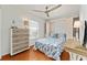 Charming bedroom with Murphy bed, a dresser, desk, and bright natural light at 219 Carrera Dr, The Villages, FL 32159