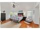 Serene bedroom with a ceiling fan, hardwood floors, and a colorful tropical themed comforter at 219 Carrera Dr, The Villages, FL 32159