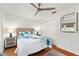 Bright bedroom featuring a ceiling fan, closet, and a cozy bed with side tables at 219 Carrera Dr, The Villages, FL 32159