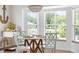Cozy dining area with bay windows providing scenic views and a stylish, round table at 219 Carrera Dr, The Villages, FL 32159
