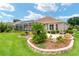 Beautiful exterior view of the home showcasing the landscaped backyard, screened lanai, and well-maintained grounds at 219 Carrera Dr, The Villages, FL 32159