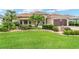 Well-manicured front yard with lush landscaping and charming single-story home at 219 Carrera Dr, The Villages, FL 32159