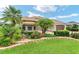 Beautiful single-story home featuring well-manicured landscaping and a two-car garage at 219 Carrera Dr, The Villages, FL 32159