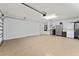 Spacious two car garage with epoxy floor, laundry sink, and ample storage space at 219 Carrera Dr, The Villages, FL 32159