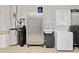 Organized garage featuring a washer, dryer, sink, storage, water heater, and water softener system at 219 Carrera Dr, The Villages, FL 32159