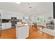 Well-lit kitchen with white cabinetry, stainless steel appliances, and granite countertops for modern cooking at 219 Carrera Dr, The Villages, FL 32159