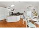 Bright kitchen boasts white cabinets, granite counters, and a stylish dining area with a unique chandelier at 219 Carrera Dr, The Villages, FL 32159