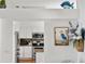 Open-concept kitchen showcasing stainless steel appliances, granite counters, and white cabinetry at 219 Carrera Dr, The Villages, FL 32159