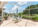 Serene covered lanai with seating area and view of the manicured backyard and golf course at 219 Carrera Dr, The Villages, FL 32159