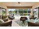 Relaxing lanai with comfortable wicker furniture, a ceiling fan, and a peaceful outdoor view at 219 Carrera Dr, The Villages, FL 32159