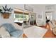 Cozy living room with access to a screened lanai, ideal for indoor-outdoor living and relaxation at 219 Carrera Dr, The Villages, FL 32159