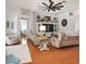 Inviting living room with hardwood floors, a ceiling fan, and comfortable seating at 219 Carrera Dr, The Villages, FL 32159
