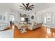 Spacious living room featuring hardwood floors, ceiling fan, and comfortable seating arrangement at 219 Carrera Dr, The Villages, FL 32159