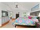Well-lit main bedroom boasts wood floors, ceiling fan, backyard access, and a large window at 219 Carrera Dr, The Villages, FL 32159