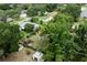 Aerial view highlighting a property with mature trees, a pool, and backyard sheds at 2202 Butler St, Leesburg, FL 34748