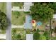 Aerial view of property featuring a private backyard with a pool, wooden deck and mature trees at 2202 Butler St, Leesburg, FL 34748