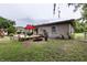 The house has a backyard with a deck, lawn furniture, landscaping and a fire pit at 2202 Butler St, Leesburg, FL 34748