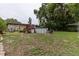 Backyard featuring a pool and small staircase to a deck in a fenced in yard at 2202 Butler St, Leesburg, FL 34748