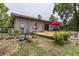View of the deck and backyard with an assortment of potted plants and lawn furniture at 2202 Butler St, Leesburg, FL 34748