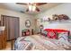 Cozy bedroom featuring a ceiling fan and Southwestern-inspired decor at 2202 Butler St, Leesburg, FL 34748