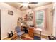 Bedroom with a wooden desk, a ceiling fan, and natural light from the window at 2202 Butler St, Leesburg, FL 34748