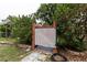 Enclosed outdoor shower surrounded by foliage at 2202 Butler St, Leesburg, FL 34748