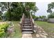 Wooden staircase in the backyard leading to a deck at 2202 Butler St, Leesburg, FL 34748