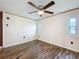 Bright, simple bedroom featuring modern flooring and a ceiling fan for comfortable living at 239 Rue De Fontaine, Tavares, FL 32778