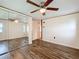 Bright bedroom featuring modern flooring, a large mirrored closet, and a ceiling fan at 239 Rue De Fontaine, Tavares, FL 32778