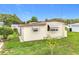 A cozy mobile home with a manicured lawn and awning-covered windows at 239 Rue De Fontaine, Tavares, FL 32778