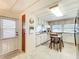 A quaint kitchen features white cabinets, pink countertops, and a dining area perfect for casual meals at 239 Rue De Fontaine, Tavares, FL 32778