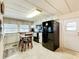 Efficient kitchen featuring white cabinets, appliances, and a cozy dining area for everyday living at 239 Rue De Fontaine, Tavares, FL 32778